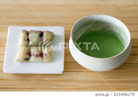 Cup of fresh matcha tea, green tea and Coconut steamed sticky rice with banana, Thailand dessert on wooden table. Cup of fresh matcha tea, green tea and Coconut steamed sticky rice with banana, Thailand dessert on wooden table. 123490279
