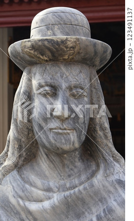 A stone sculpture carved into the shape of a human figure 123491137