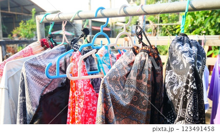 Freshly washed clothes drying on a clothesline under the sun Freshly washed clothes drying on a clothesline under the sun 123491458