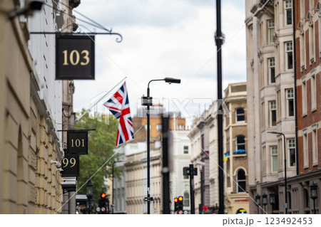 London street captures the essence of British heritage with classic architecture, numbered storefronts, and a Union Jack flag adding a patriotic touch. London street captures the essence of British heritage with classic architecture, numbered storefronts, and a Union Jack flag adding a patriotic touch. 123492453