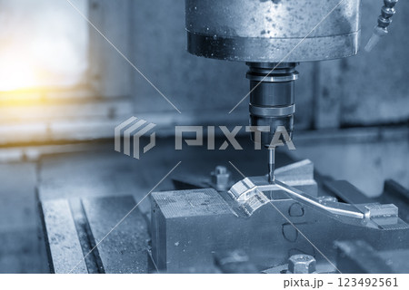 The CNC milling machine cutting mold part by solid ball nose end mill tool in the light blue scene with lighting effect. The CNC milling machine cutting mold part by solid ball nose end mill tool in the light blue scene with lighting effect. 123492561