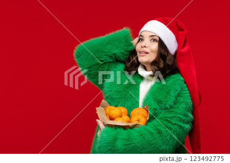 Woman in Santa hat and green coat 123492775