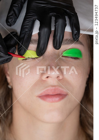 Caucasian woman undergoing eyelash lamination procedure. Caucasian woman undergoing eyelash lamination procedure. 123494737