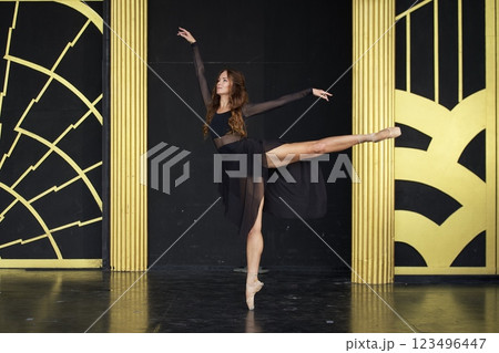 Elegant Ballet Dancer in Black Dress Performing on Stage  123496447