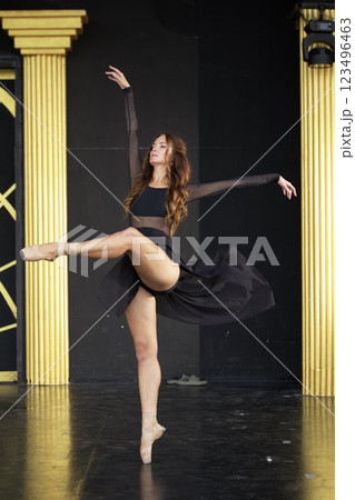 Elegant Ballet Dancer Performing on Stage in Black Dress  123496463