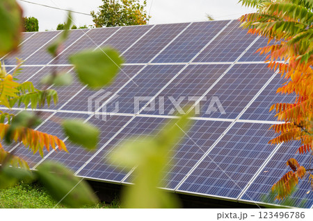 A rooftop equipped with solar panels gathers sunlight to generate electricity. This setup demonstrates renewable energy efforts in a sunny environment with lush greenery A rooftop equipped with solar panels gathers sunlight to generate electricity. This setup demonstrates renewable energy efforts in a sunny environment with lush greenery 123496786