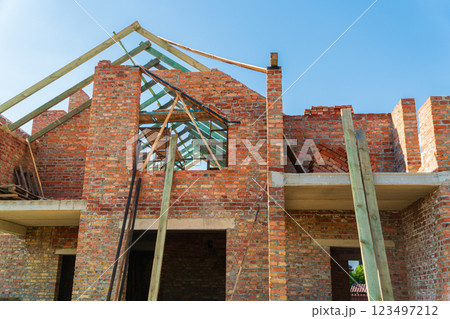 Construction of a house. Construction of a red brick house. Modern construction Construction of a house. Construction of a red brick house. Modern construction 123497212