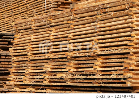 Stack of fresh pine boards in a sawmill warehouse Stack of fresh pine boards in a sawmill warehouse 123497403