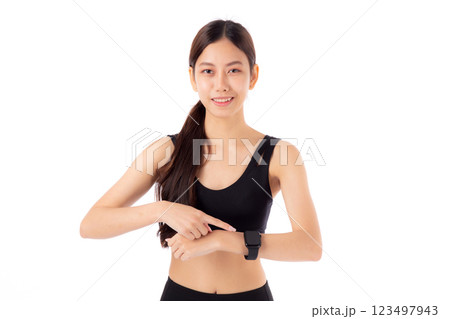 Happy young asian woman looking and pointing smartwatch for exercise and aerobics with cardio. 123497943