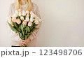 A woman holding a bouquet of white and pink roses 123498706