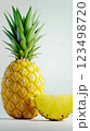 A pineapple with a slice cut in half next to it 123498720