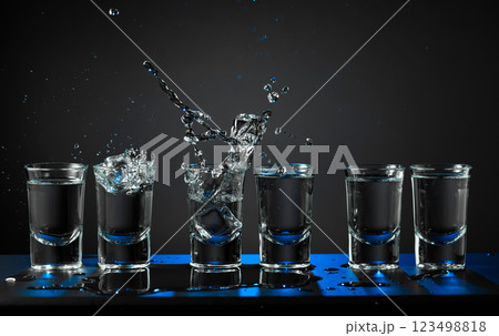 Alcoholic shots of vodka or strong drink in small glasses. 123498818