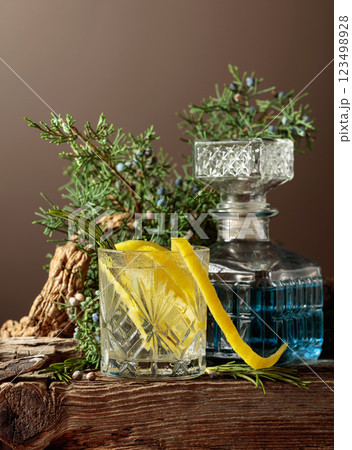 Cocktail gin-tonic with ice, lemon, and rosemary in a frozen glass. 123498928