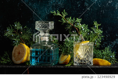 Cocktail gin-tonic with ice, lemon, and rosemary in a frozen glass. Cocktail gin-tonic with ice, lemon, and rosemary in a frozen glass. 123498929