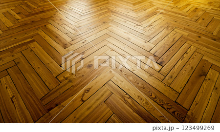 A wooden floor with a herringbone pattern on it 123499269
