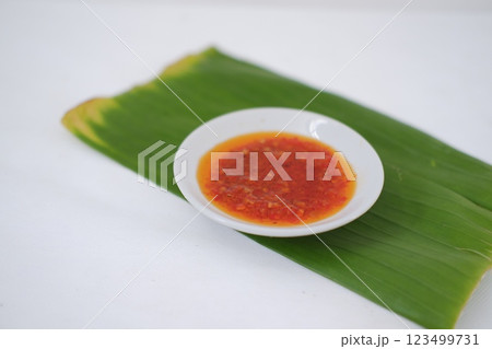 Thai style chili paste on banana leaf on a white background. 123499731