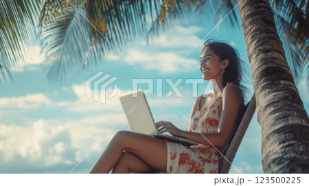 Happy Woman Working Remotely on the Beach 123500225