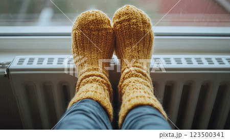 Warm Yellow Wool Socks on Radiator 123500341