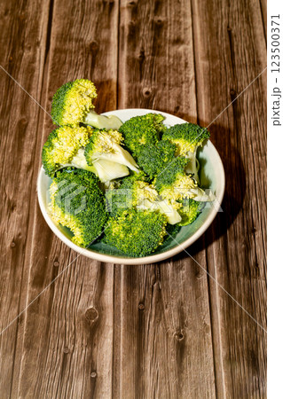 Plate with broccoli on a wooden table 123500371