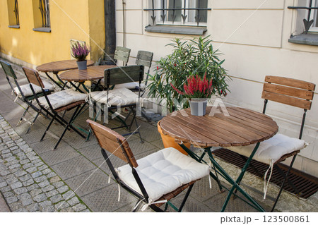 City cafe wooden tables decorated with heather in autumn style standing outside City cafe wooden tables decorated with heather in autumn style standing outside 123500861