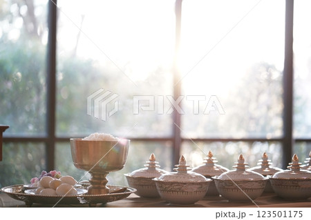 Thai bowl set on table prepare for give food offerings to a Buddhist monk in the morning. People usually prepare rice, dishes and flower offer food to monk. 123501175
