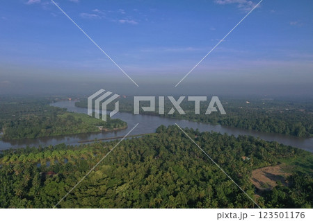 Daytime aerial view Bang Pakong river in Chachoengsao province, Thailand. Bang Pakong River landscape view at Chachoengsao by the greenery forest and harbor riverside. 123501176