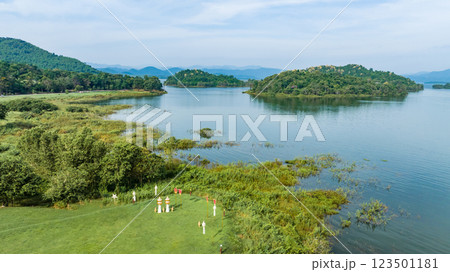 Kaeng Krachan dam with lake view and many green moutain, blue sky background. Kaeng Krachan Dam national park, Phetchaburi province, Thailand in aerial view from drone. 123501181