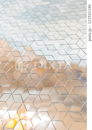 Shiny mirror cut in a cube shape for decorating wall and floor, laying mirror tile in 3d cube geometric pattern. 123501190