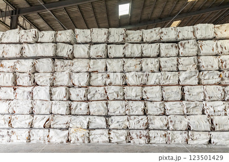 The natural Thai standard rubber bales sheet products staked and stored in the factory warehouse. The storage procession product of a rubber factory. The natural Thai standard rubber bales sheet products staked and stored in the factory warehouse. The storage procession product of a rubber factory. 123501429