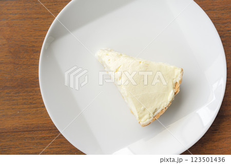 Clear Coconut Cream Pie in the dish on the wood table without anything topping on it. Shooting in the sunlight. Clear Coconut Cream Pie in the dish on the wood table without anything topping on it. Shooting in the sunlight. 123501436