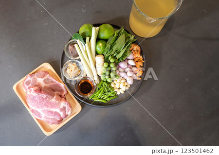 Herb ingredients and pork in topview and flatlay are prepared for Thai Food cooking menu on the counter kitchen, ready to process. 123501462