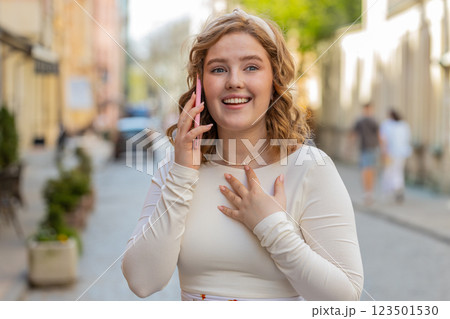 Happy surprised woman involved in pleasant conversation phone call good news enjoying talking gossip Happy surprised woman involved in pleasant conversation phone call good news enjoying talking gossip 123501530