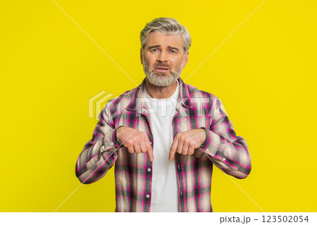 Mature man urging donations, heartfelt plea, pointing down gesture support call, genuine gratitude Mature man urging donations, heartfelt plea, pointing down gesture support call, genuine gratitude 123502054