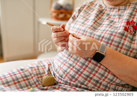 Close-up view of hands of an older woman crocheting 123502905