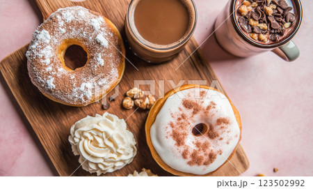 Sweet treats served with hot beverages on a wooden tray in a cozy cafe 123502992