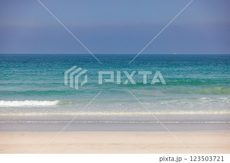 A pristine beach with turquoise waters and golden sand in the UAE 123503721
