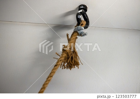 Strong rope knot connection with metal clip in detailed close up with white background 123503777