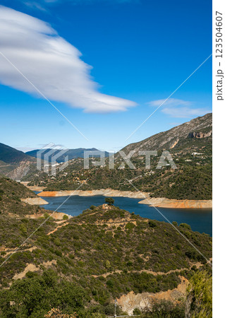 Scenic mountain lake landscape with clear blue sky and vibrant greenery, La Concepcion reservoir in 123504607