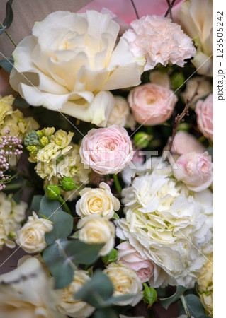 Delicate composition of white and pink roses in a basket Delicate composition of white and pink roses in a basket 123505242