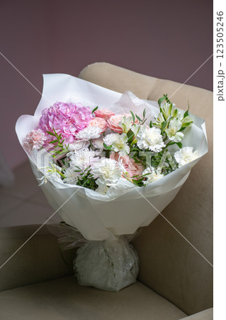Delicate composition of white and pink roses in a basket 123505246