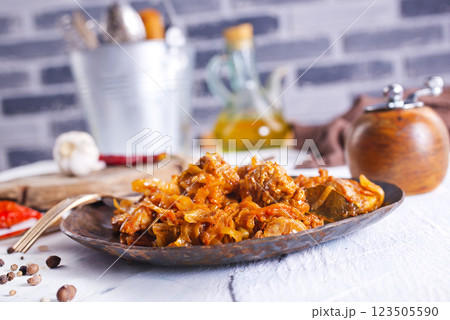 Stewed or braised cabbage served on dark plate 123505590