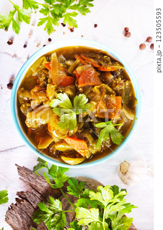Baked vegetable salad in a cermaic bowl over light background. Delicious healthy autumn or winter salad, seasonal food. 123505593