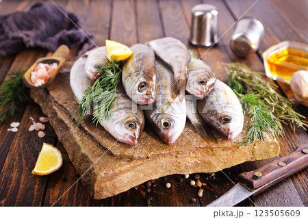 Fresh small fish on stone board 123505609