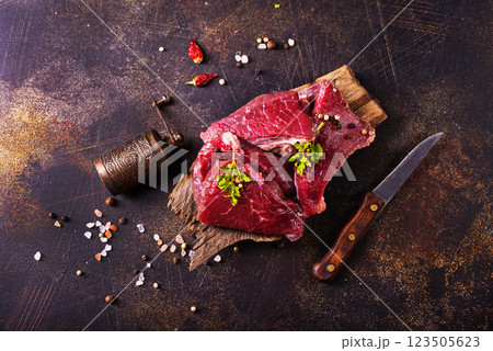 Raw marbled beef steaks on a dark slate, stone or concrete background . Raw marbled beef steaks on a dark slate, stone or concrete background . 123505623