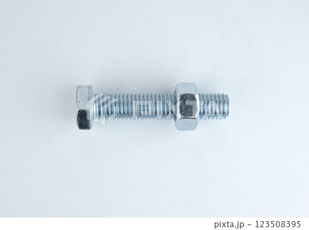Metal bolt with nut on a plain background for hardware use Metal bolt with nut on a plain background for hardware use 123508395