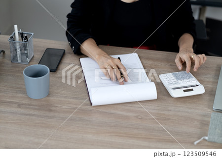 senior business woman is using a calculator senior business woman is using a calculator 123509546