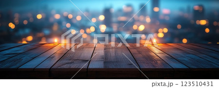 Wooden Table Surface with Sunset Blurry Cityscape and Nature Background, Warm Tones, and Soft Focus Lights Creating a Cozy Atmosphere for Relaxation Wooden Table Surface with Sunset Blurry Cityscape and Nature Background, Warm Tones, and Soft Focus Lights Creating a Cozy Atmosphere for Relaxation 123510431