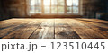 Wooden Table Surface with Sunset Blurry Cityscape and Nature Background, Warm Tones, and Soft Focus Lights Creating a Cozy Atmosphere for Relaxation 123510445