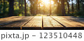 Wooden Table Surface with Sunset Blurry Cityscape and Nature Background, Warm Tones, and Soft Focus Lights Creating a Cozy Atmosphere for Relaxation 123510448