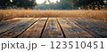 Wooden Table Surface with Sunset Blurry Cityscape and Nature Background, Warm Tones, and Soft Focus Lights Creating a Cozy Atmosphere for Relaxation 123510451